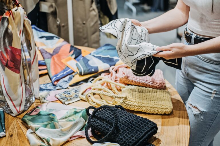 Sustainable fashion. Modern Latina young woman choosing vintage scarf,